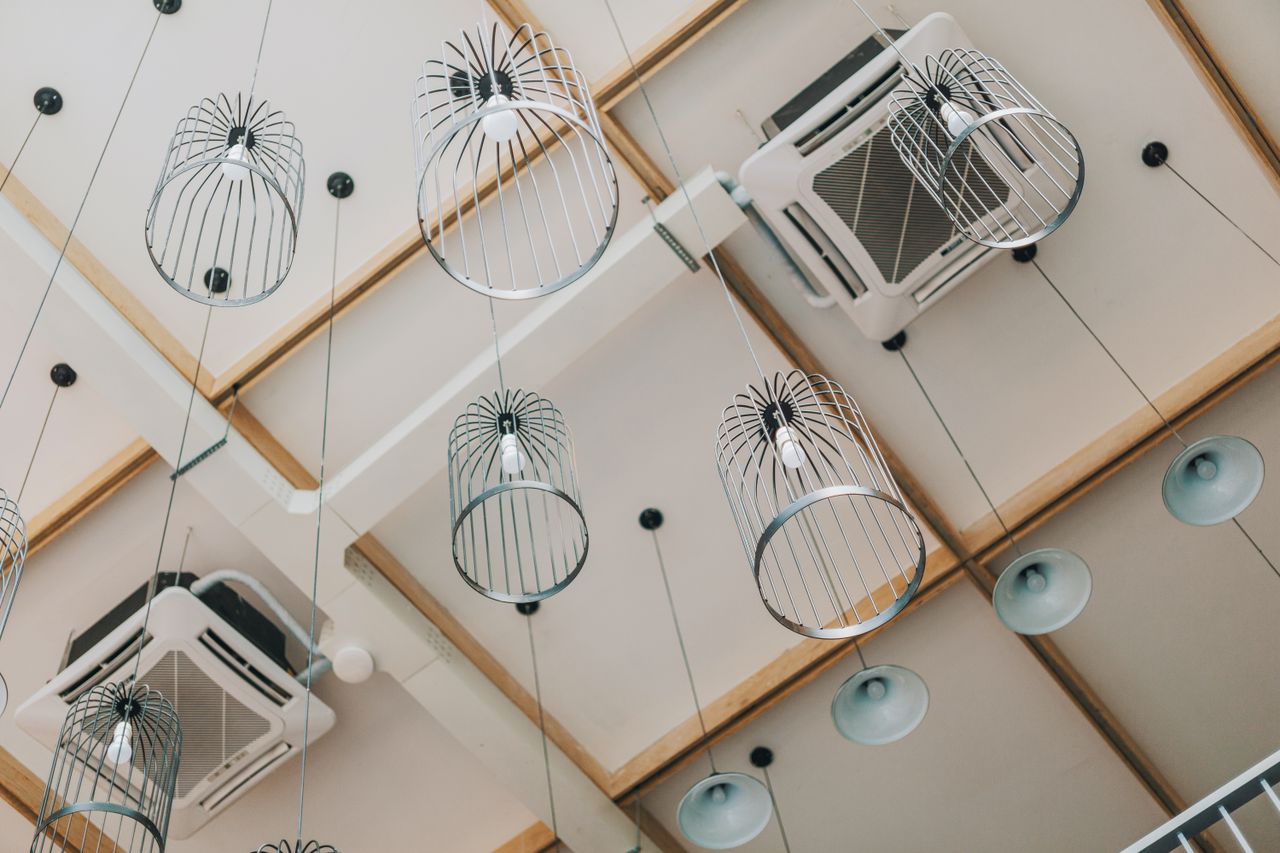 Crafting Captivating Headlines: Your awesome post title goes here Low angle view of modern pendant lamps in a contemporary interior with a uniquely designed ceiling.